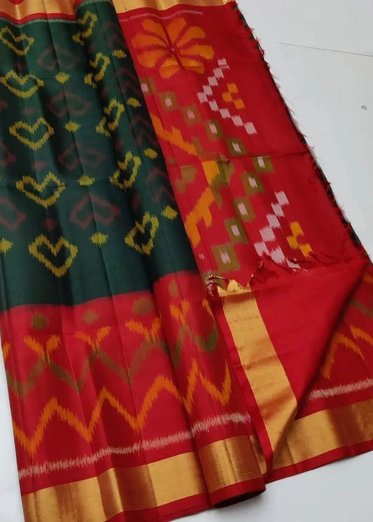 Traditional saree with green, red, and orange patterns on a white background