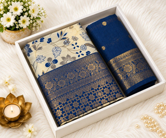 Navy blue Banarasi silk saree with ivory floral print body and broad gold zari navy blue border, shown in a white gift box with the matching navy blue unstitched blouse piece