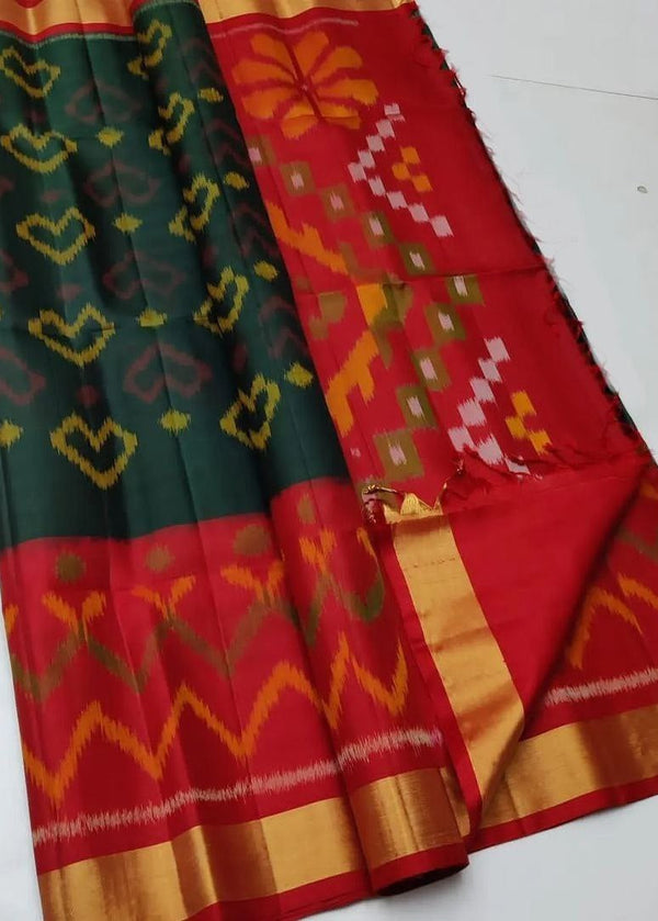 Traditional saree with green, red, and orange patterns on a white background