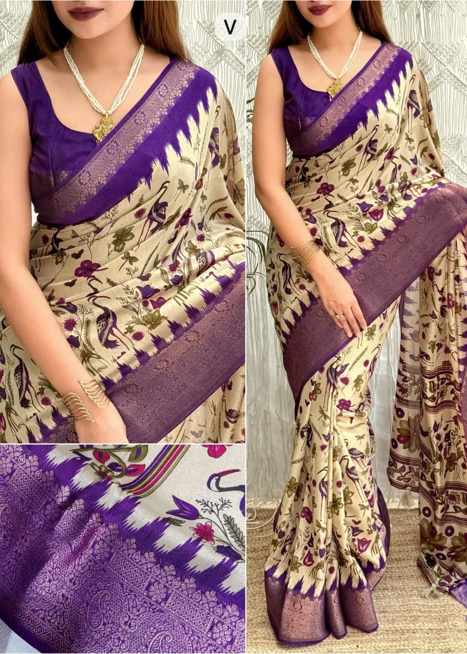 Woman wearing a purple and beige saree with intricate patterns, displayed against a neutral background.