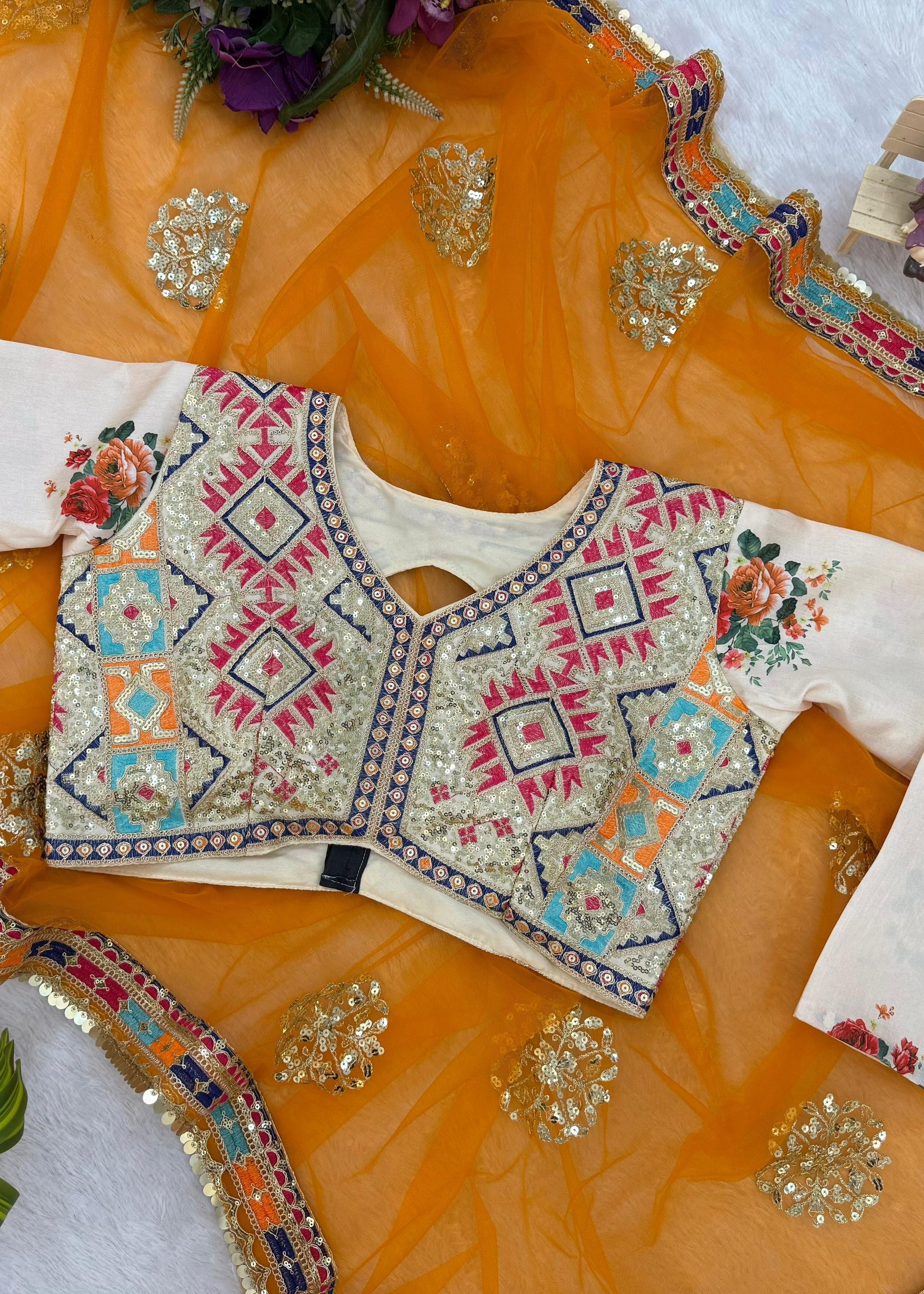Traditional embroidered blouse on a decorative orange fabric background