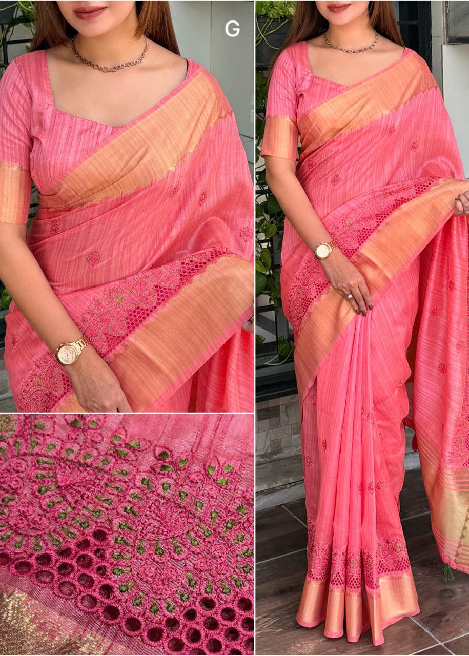 Woman wearing a pink saree with a close-up of the fabric details.