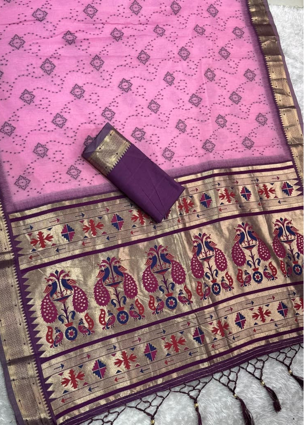 Pink saree with intricate patterns and a purple blouse on a textured surface