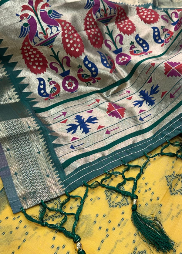 Colorful embroidered fabric with peacock patterns on a yellow background