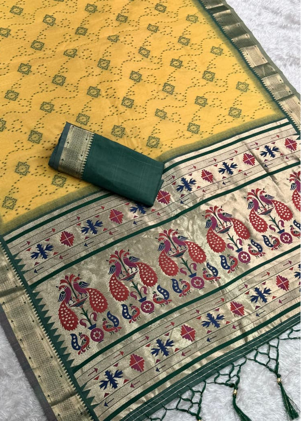 Traditional saree with a yellow and green pattern on a textured surface