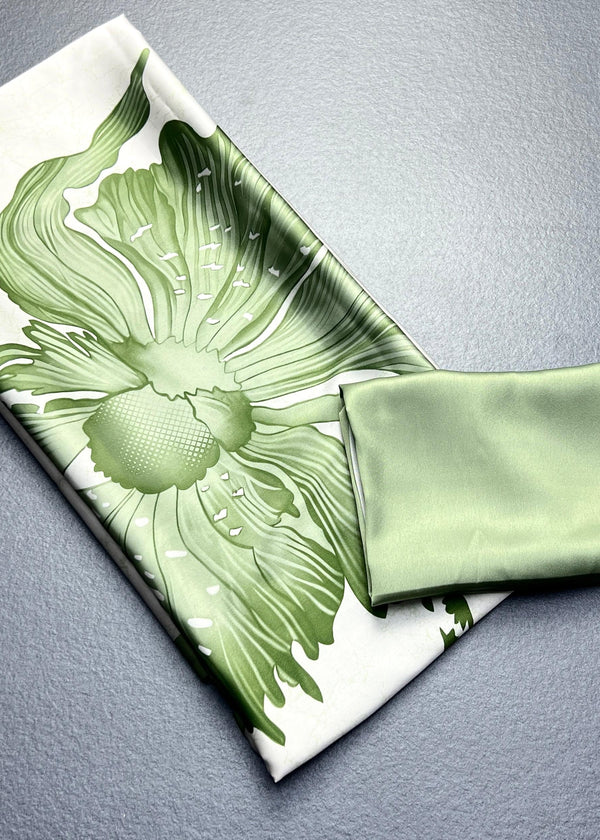 Green floral-patterned fabric on a gray surface