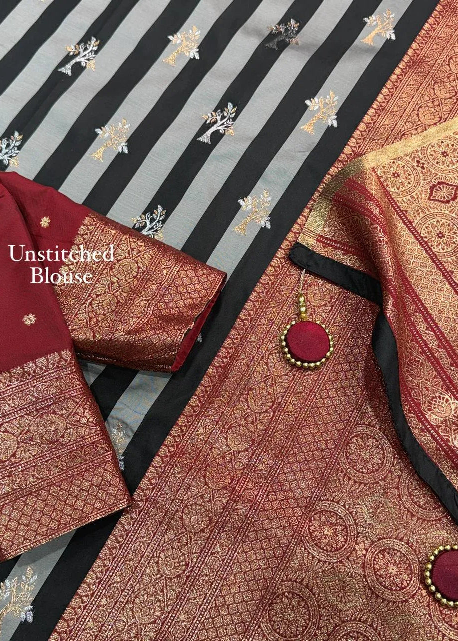 Unstitched blouse with intricate patterns on a striped fabric background