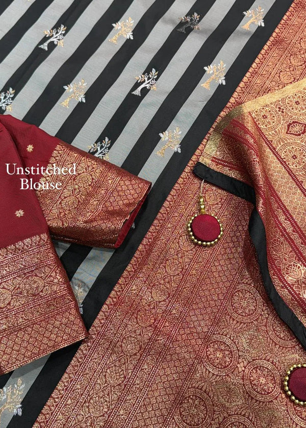 Unstitched blouse with intricate patterns on a striped fabric background