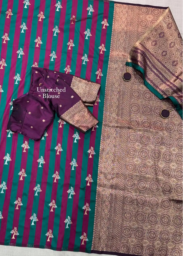 Saree with a purple and green patterned border and an unstitched blouse on a matching fabric background.