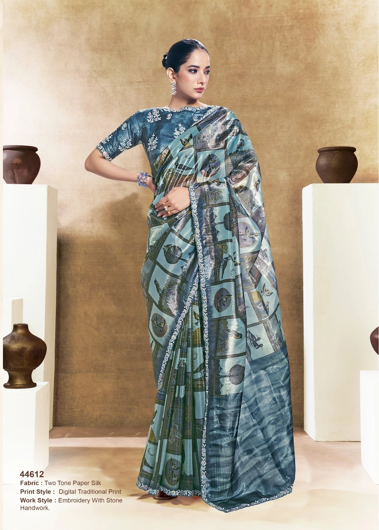 Woman wearing a traditional saree with a geometric pattern in a decorative setting.