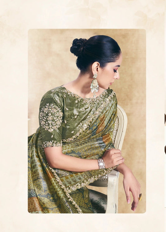 Woman wearing a green saree with a pattern, sitting and standing against a neutral background.