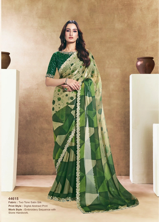 Two women wearing green sarees with leaf patterns against a beige background.