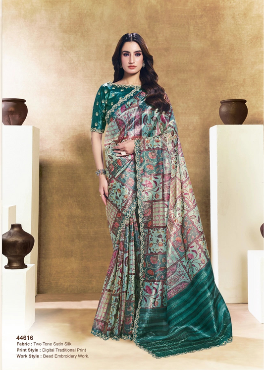 Two women wearing traditional sarees with a neutral background