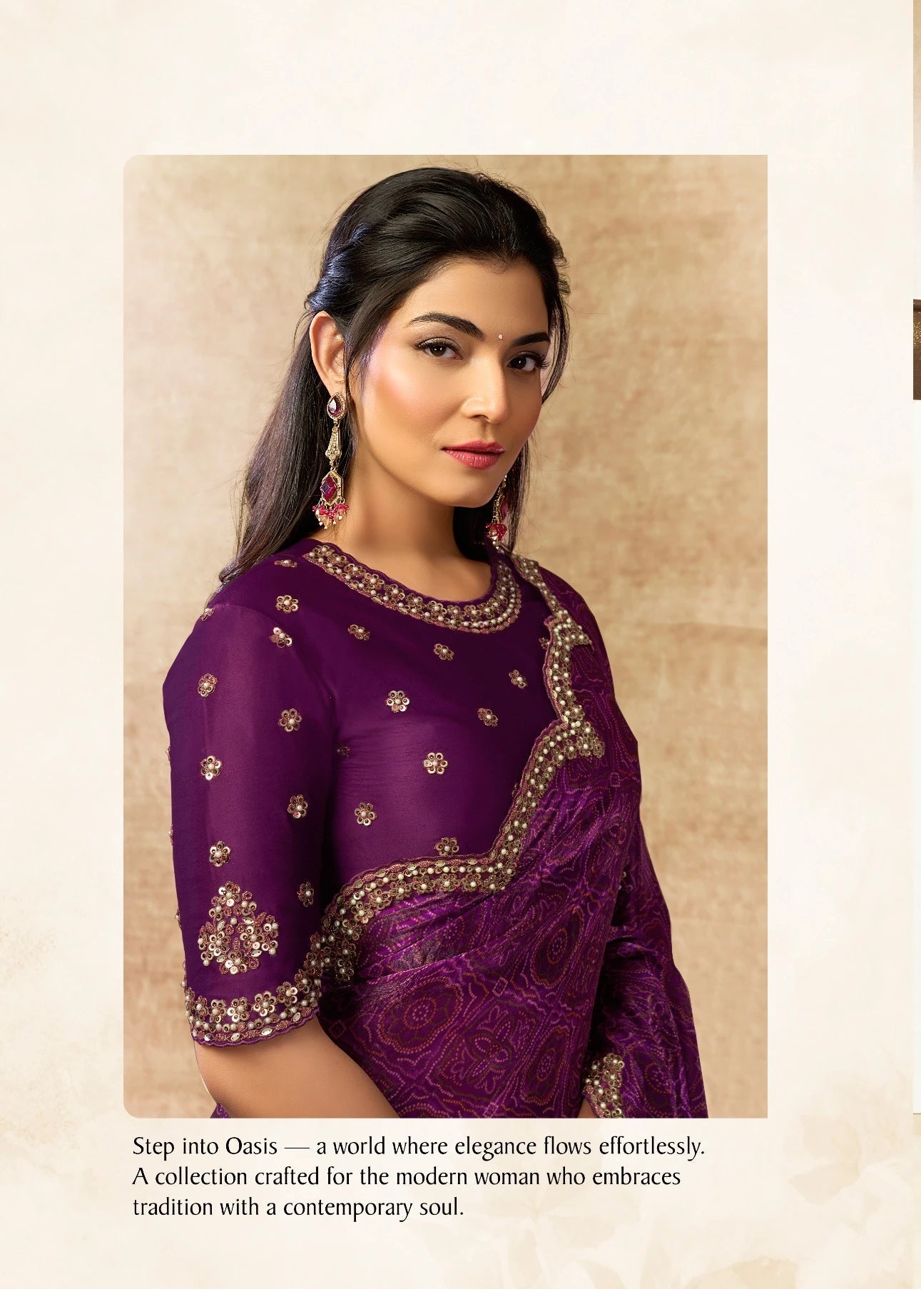 Woman wearing a purple saree with gold embroidery in an indoor setting.