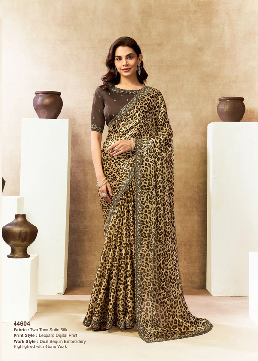 Woman wearing a leopard print saree with a plain background