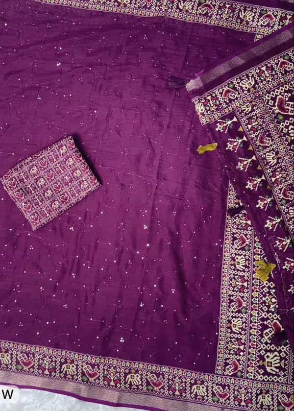Purple fabric with intricate patterns and a small pouch on a white background