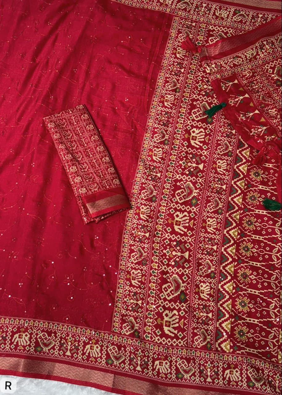 Red embroidered fabric with intricate patterns on a plain background