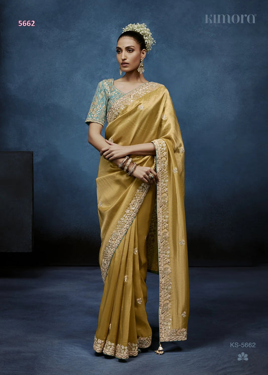 Woman in a yellow saree with a blue background
