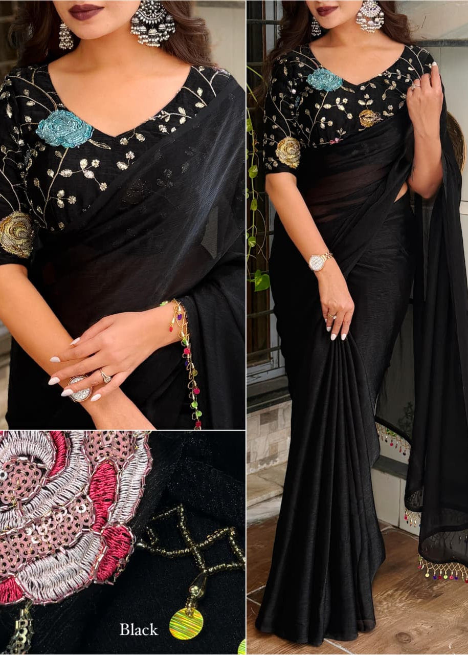 Black saree with floral and geometric patterns, worn by a model indoors.