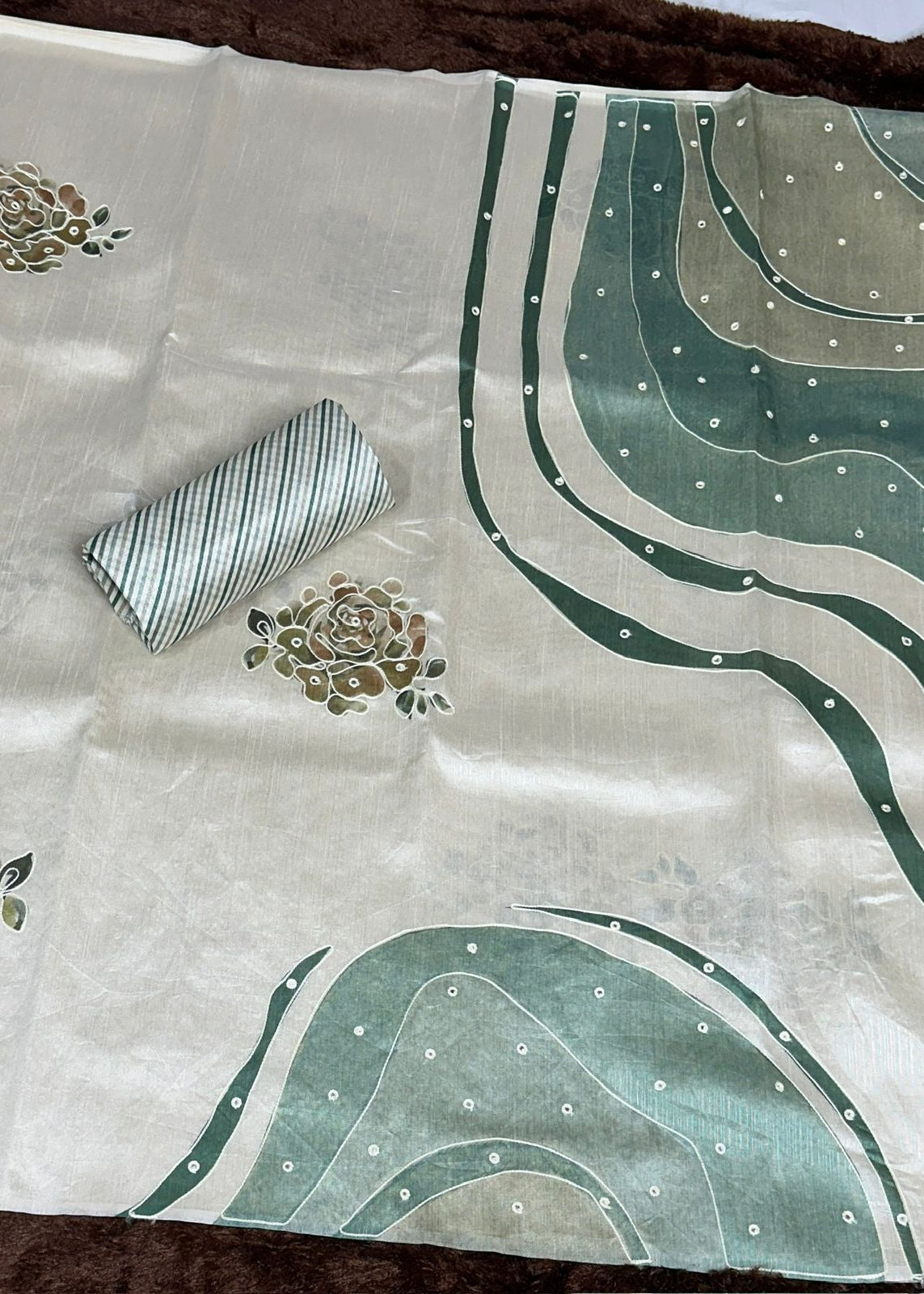 Fabric with green floral and abstract patterns on a white background