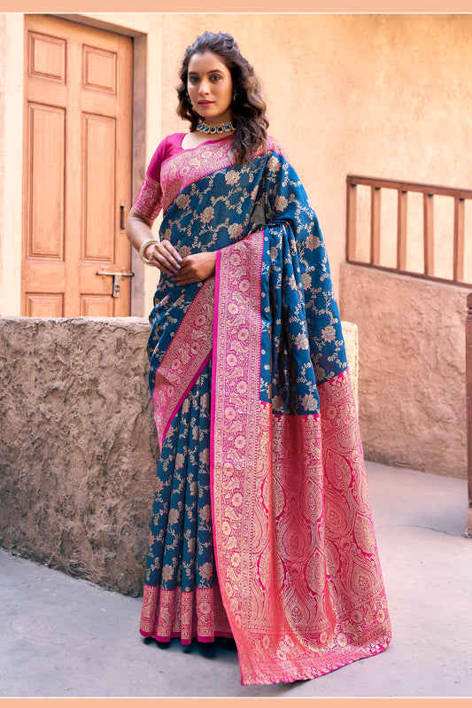 Woman wearing a blue and pink saree with a Gobuni label in the corner.