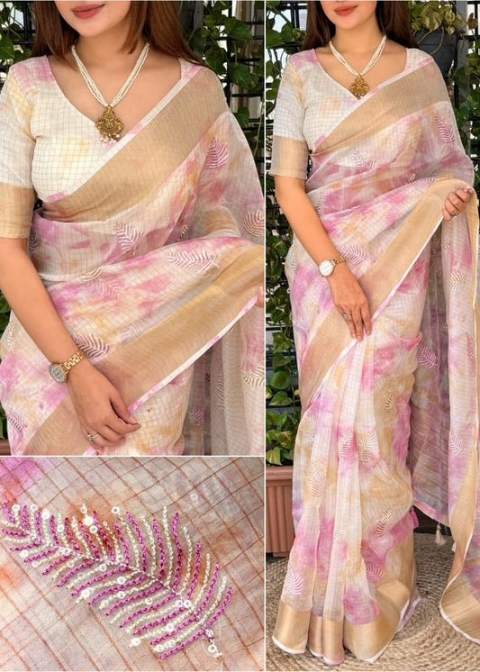 Woman wearing a pink and beige saree with a close-up of decorative details.