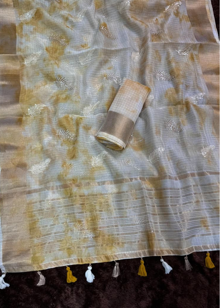 Saree with gold and white patterns on a dark background
