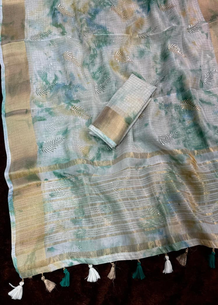 Saree with floral patterns and tassels on a dark background