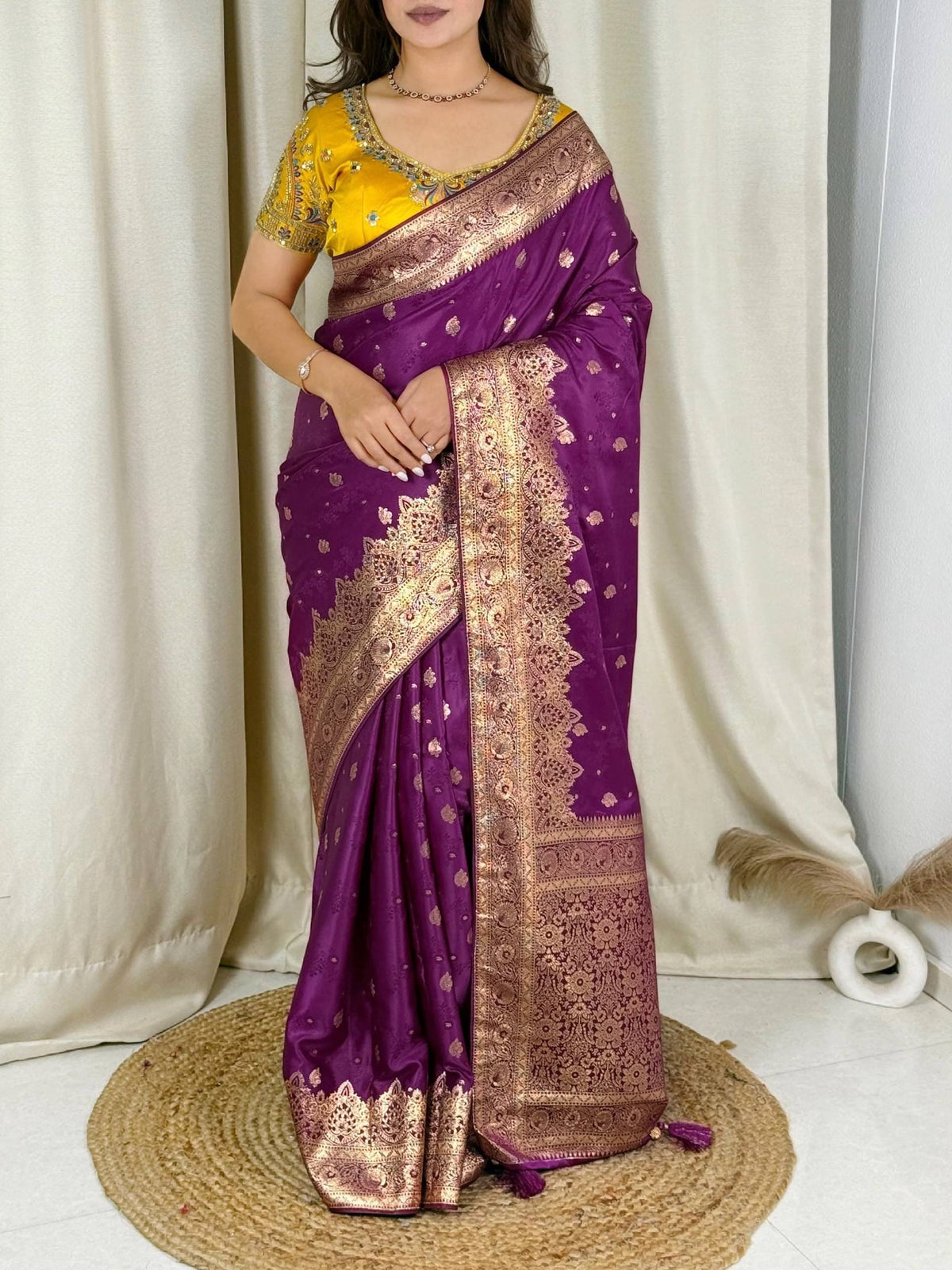 Model wearing a purple Banarasi satin silk saree with a yellow embellished blouse and rich zari border