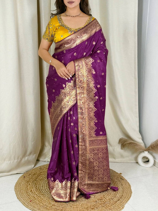 Model wearing a purple Banarasi satin silk saree with a yellow embellished blouse and rich zari border