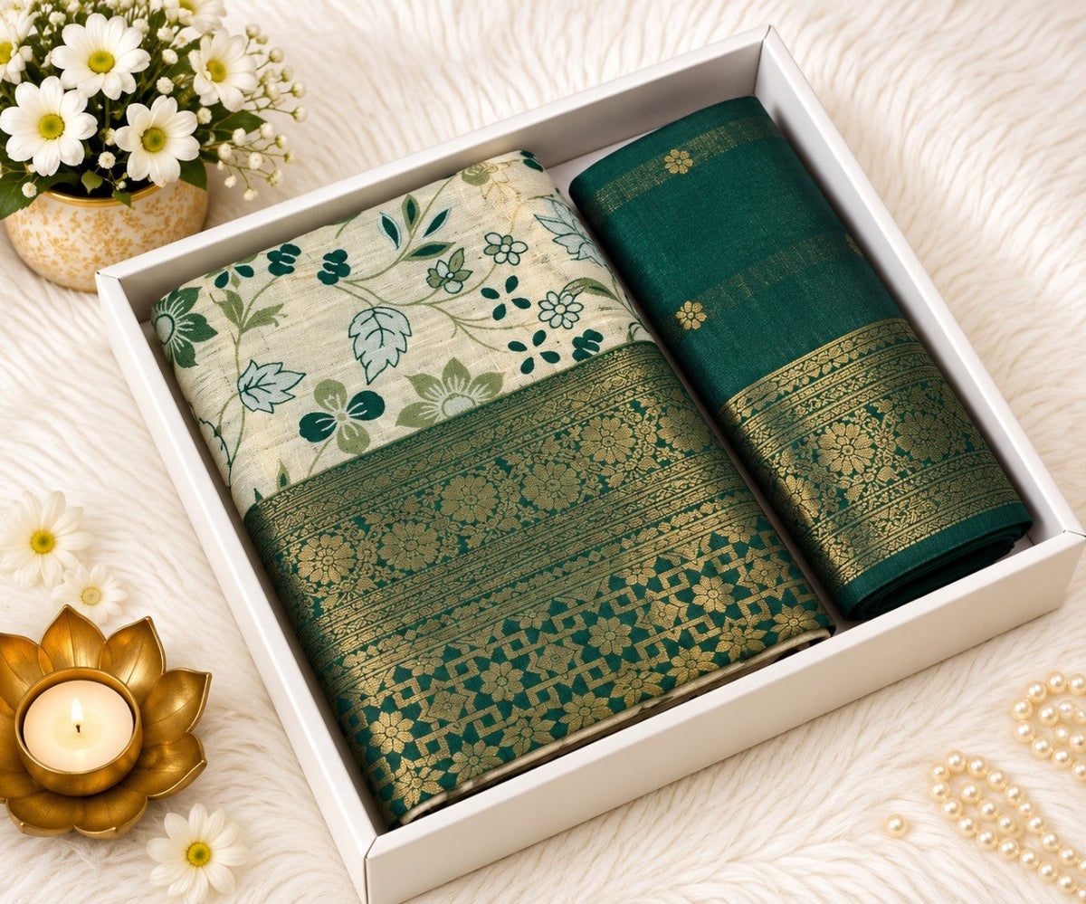 Green Banarasi silk saree with ivory floral print body and broad gold zari green border, shown in a white gift box with the matching green unstitched blouse piece