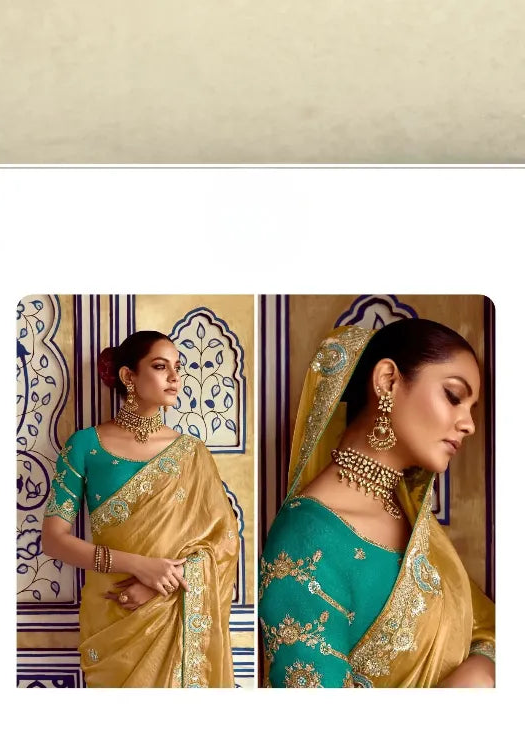 Woman in a teal blouse with gold embroidery and yellow saree, wearing jewelry.