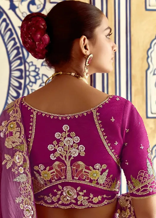 Woman wearing a purple embroidered saree with a decorative background