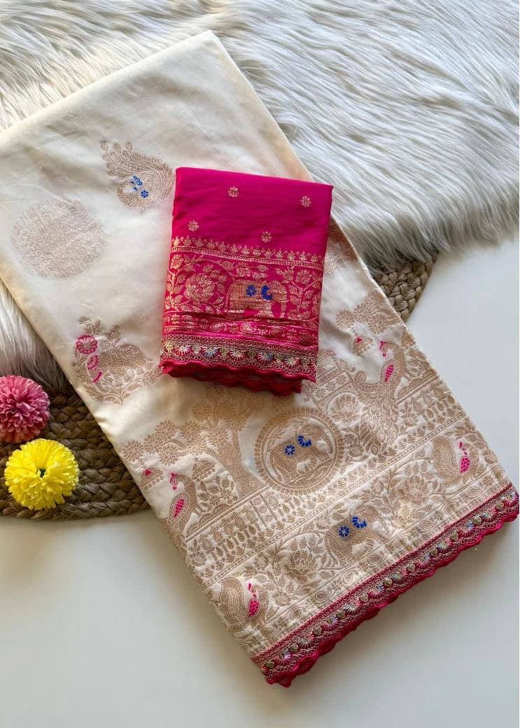 Beige saree with red border and pink blouse on a textured surface