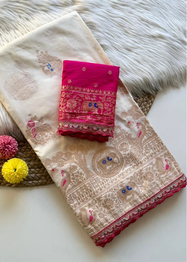 Beige saree with red border and pink blouse on a textured surface