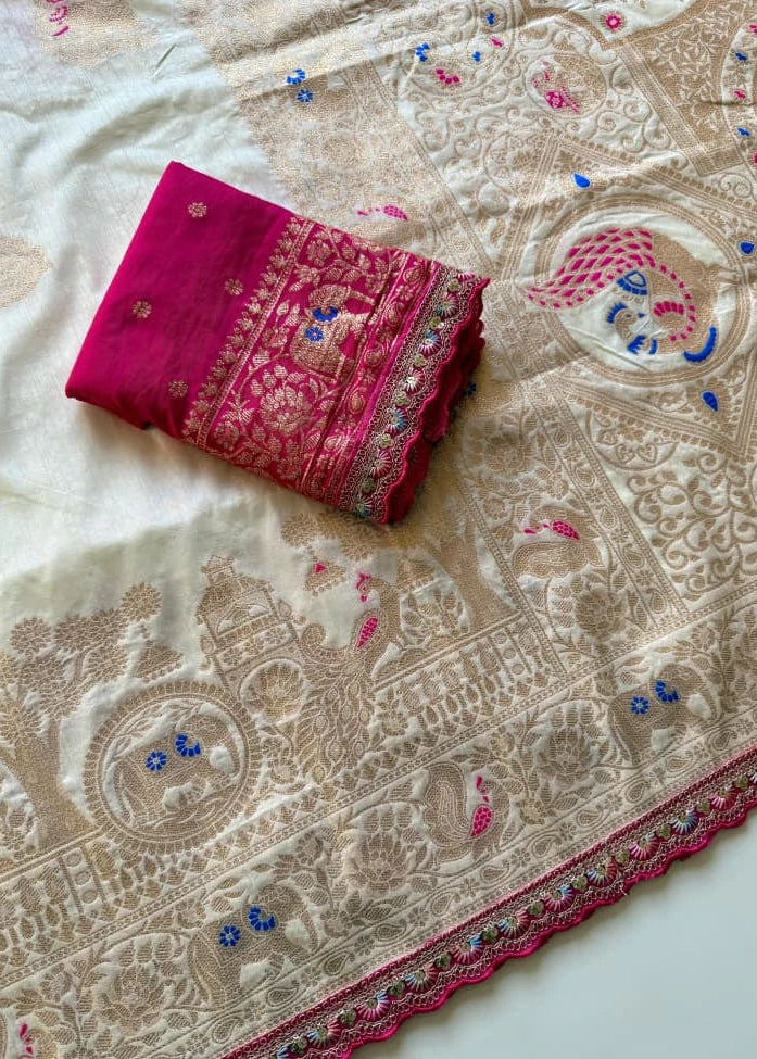 Folded pink fabric with intricate patterns on a beige embroidered fabric background