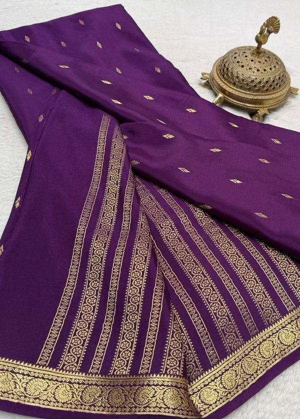 Purple saree with gold embroidery on a white background