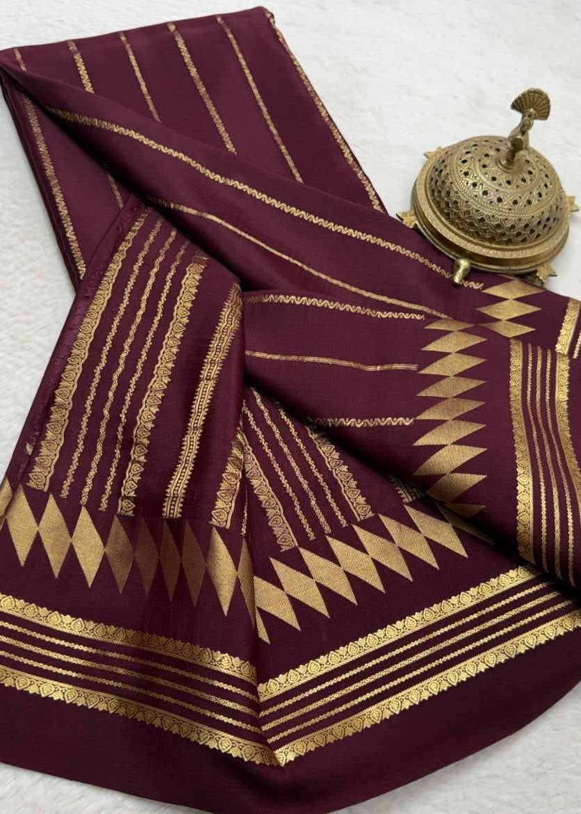 Maroon fabric with gold patterns on a white background