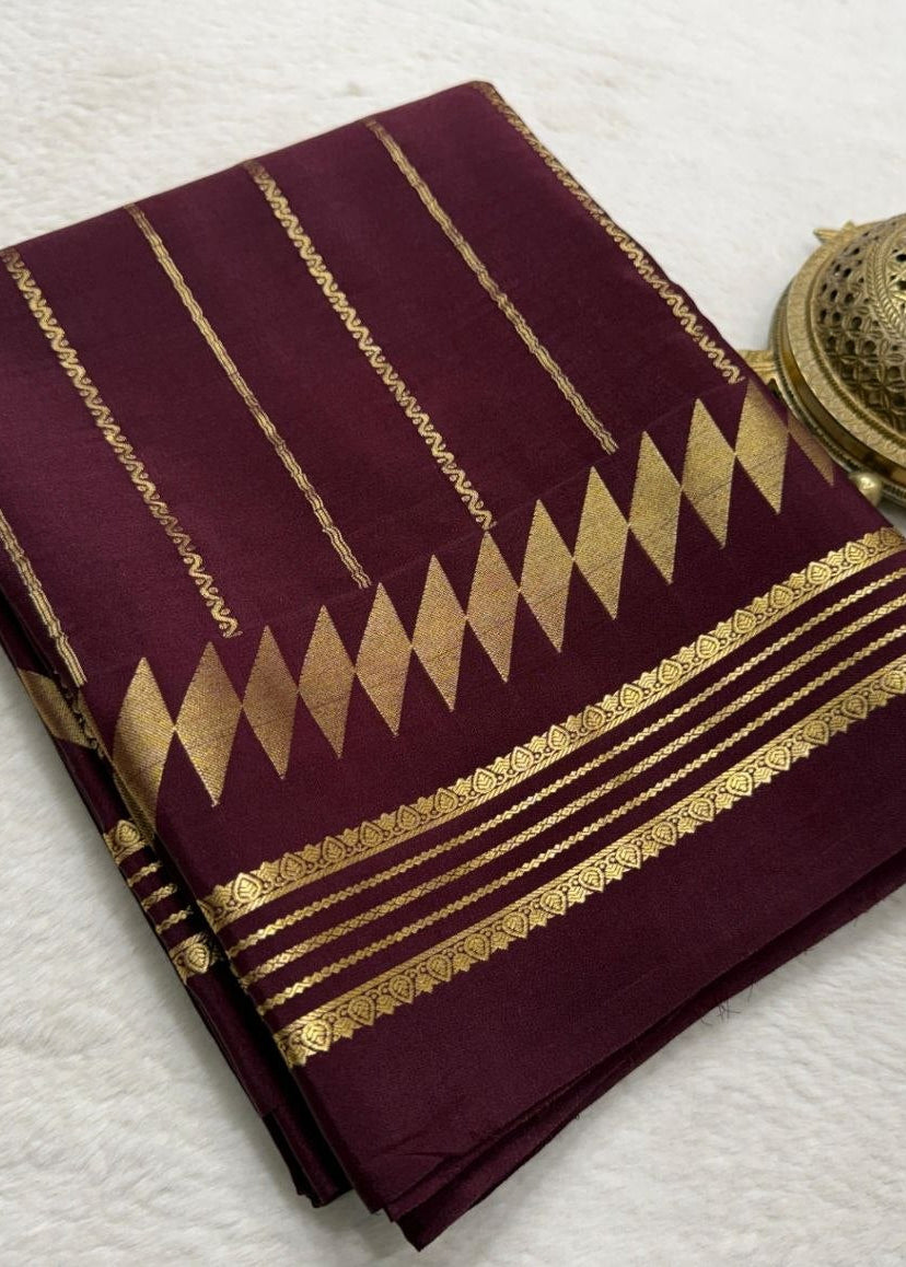 Maroon fabric with gold patterns on a white background
