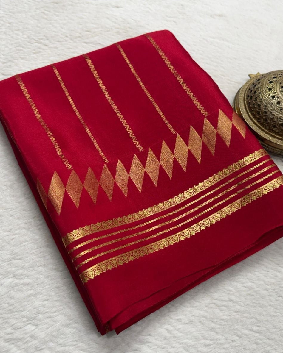 Red fabric with gold patterns on a white background