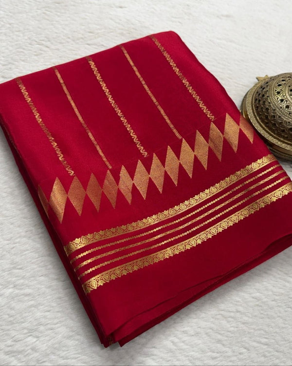 Red fabric with gold patterns on a white background
