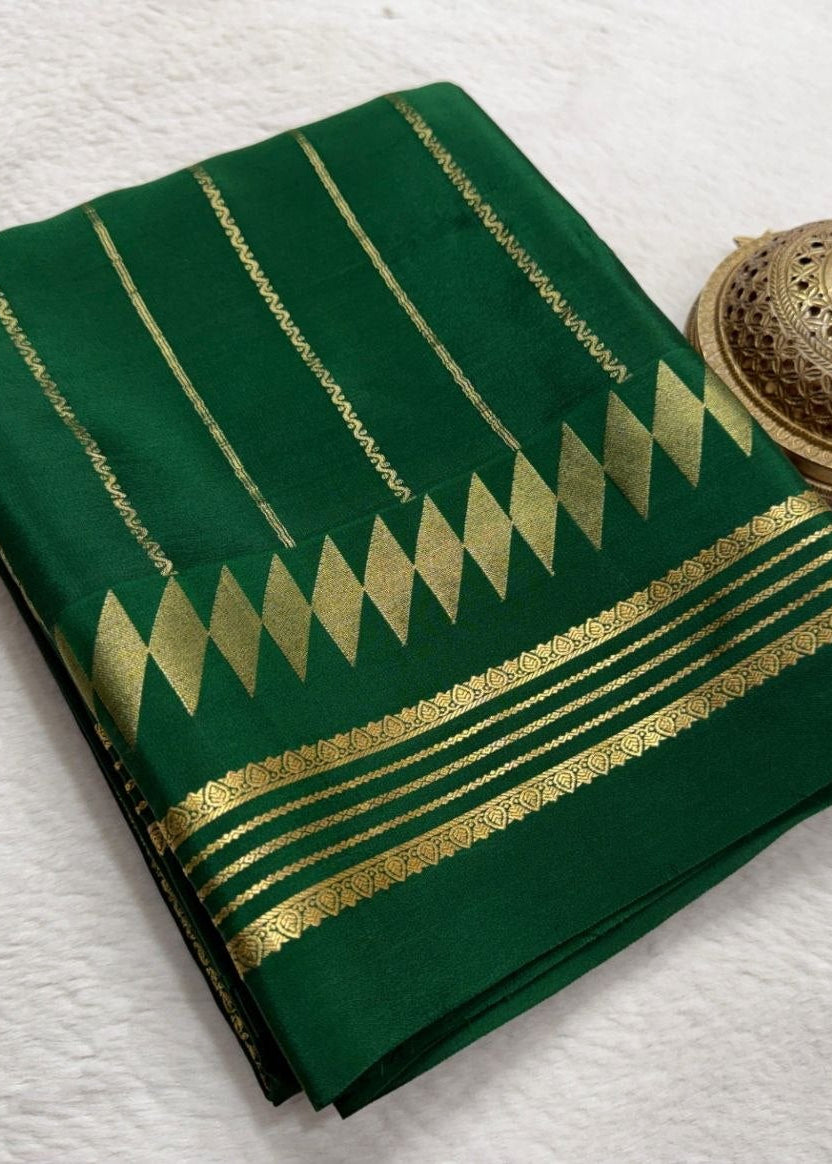 Green fabric with gold patterns and a woven object on a white background