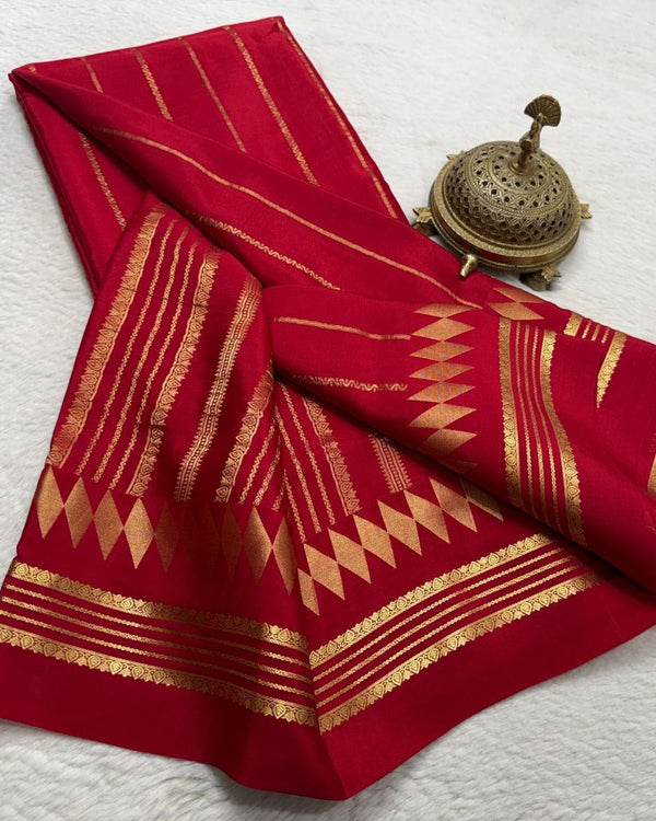 Red fabric with gold patterns on a white background