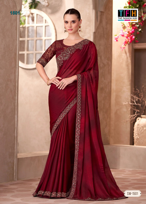 Woman wearing a maroon saree with gold border in an indoor setting
