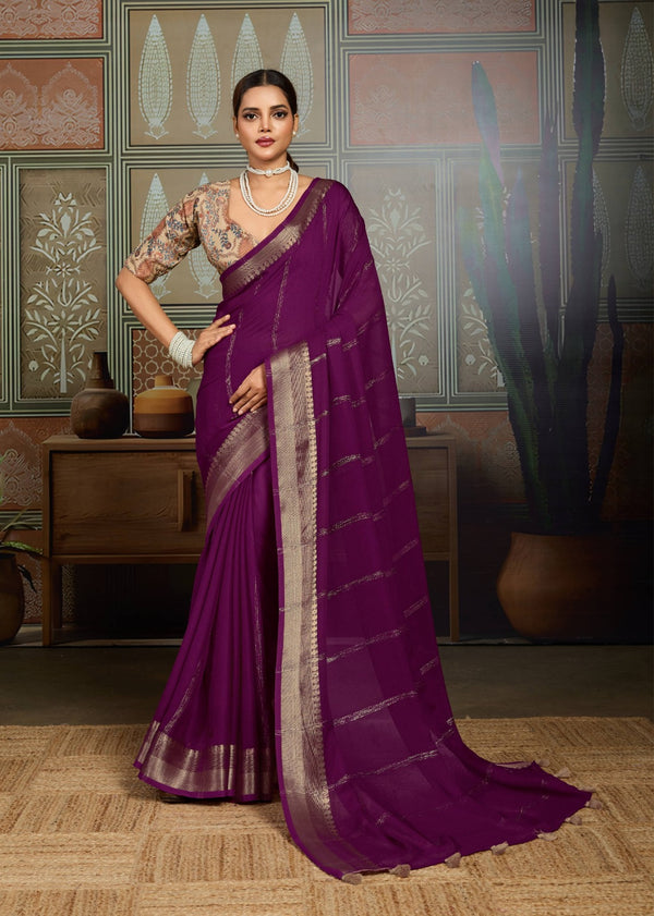 Woman wearing a purple saree with gold border in an indoor setting