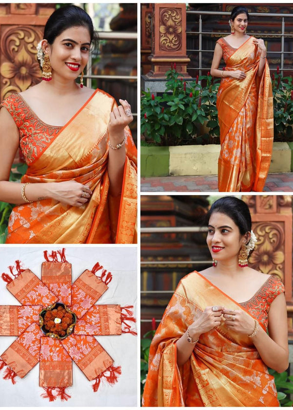 Woman wearing an orange saree with decorative elements, posing outdoors.