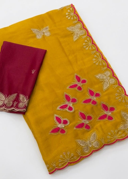 Yellow fabric with butterfly embroidery and a red fabric with floral embroidery on a white background