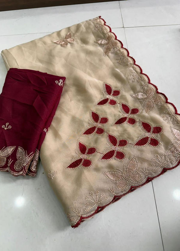 Beige fabric with red leaf patterns on a white floor
