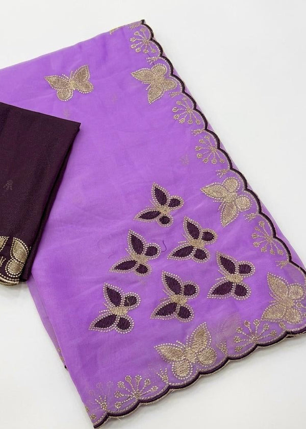 Purple fabric with butterfly embroidery and a black garment on a white background