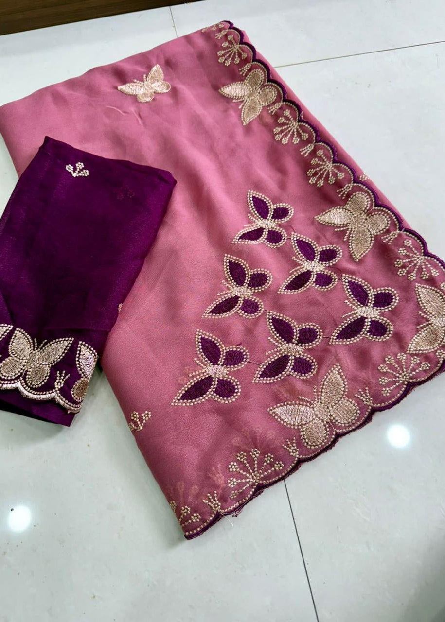 Pink and purple fabric with butterfly embroidery on a white floor.